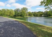 Thumbnail 10 of 11 - Glendale Heights Apartments for Rent - The Mark - walking trail path next to a lake pond in a park
