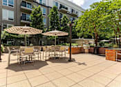 Thumbnail 39 of 39 - A patio with tables and chairs and umbrellas.