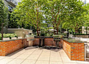 Thumbnail 34 of 39 - A courtyard with a brick wall and a fountain in the middle.