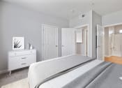 Thumbnail 5 of 19 - 1 Bedroom Apartments in Petaluma, CA - Theatre Square - Furnished Bedroom with Plush Carpet Flooring, a Closet, and an In-Suite Bathroom