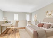Thumbnail 3 of 16 - Affinitee at Stone Mountain Apartments photo of a bedroom with a bed and a desk with a chair