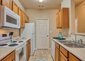 Thumbnail 5 of 25 - Clarksville, TN Apartments - Parc at Clarksville - Photo of Kitchen with storage space and white appliances