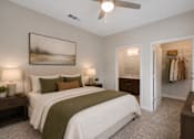 Thumbnail 6 of 17 - Professionally staged bedroom with walk-in closet at Townes at Clarkston Centre apartments in Clarkston, GA.
