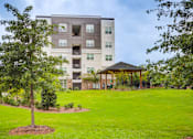 Thumbnail 16 of 17 - Landscaped community grounds at Townes at Clarkston Centre apartments in Clarkston, GA near Decatur.