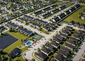 Thumbnail 46 of 47 - A bird's eye view of a residential area with houses and a swimming pool.