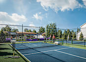 Thumbnail 45 of 47 - A tennis court with a person playing tennis.