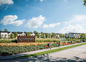 Thumbnail 44 of 47 - A sign for Townhomes is in front of a building and some trees.