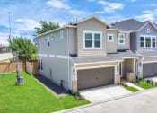Thumbnail 18 of 34 - a house with two garage doors
