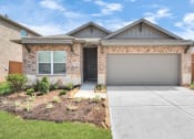 Thumbnail 3 of 39 - a house with a concrete driveway and a garage door