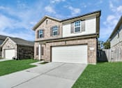 Thumbnail 8 of 41 - A two-story house with a garage is located in a residential area.