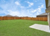 Thumbnail 38 of 39 - a backyard with green grass and a wooden fence