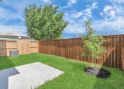 Thumbnail 31 of 34 - a backyard with green grass and a wooden fence