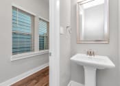 Thumbnail 29 of 34 - a bathroom with a sink and mirror
