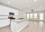 Thumbnail 20 of 39 - a kitchen with white cabinets and a white counter top
