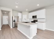Thumbnail 18 of 39 - a kitchen with white cabinets and a large island