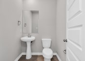 Thumbnail 28 of 39 - a bathroom with a toilet sink and mirror