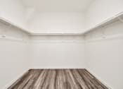 Thumbnail 37 of 41 - A room with white walls and wooden flooring.