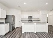 Thumbnail 20 of 41 - A kitchen with white cabinets and a granite countertop.