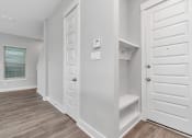 Thumbnail 27 of 34 - a walk in closet in a bedroom with a door to a closet and a window