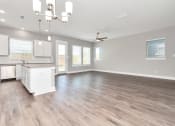 Thumbnail 24 of 34 - a kitchen and living room with hardwood floors and a chandelier