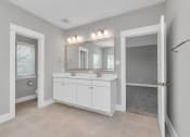 Thumbnail 28 of 34 - a bathroom with a sink and a mirror