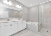 Thumbnail 15 of 34 - a bathroom with a bathtub and a sink