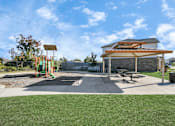 Thumbnail 41 of 41 - A playground with a swing set and a picnic pavilion.