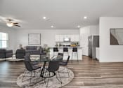 Thumbnail 27 of 41 - A modern kitchen with a dining table set in the middle of the room.