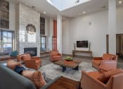 Thumbnail 3 of 21 - a living room with leather furniture and a fireplace