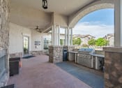 Thumbnail 14 of 21 - an outdoor kitchen with a grill and a large window