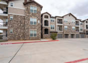 Thumbnail 19 of 21 - an empty parking lot in front of an apartment building