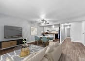 Thumbnail 7 of 12 - Overland Park, KS Apartments – Treetop Lodge – A living room with a television, a sofa, and a coffee table.