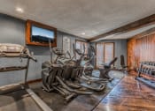 Thumbnail 3 of 12 - Treetop Lodge Apartments in Overland Park, KS photo of fitness center- free weights, cardio machines