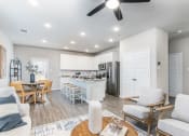 Thumbnail 6 of 39 - a living room and kitchen area with a ceiling fan