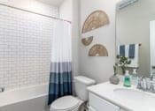 Thumbnail 13 of 39 - a bathroom with a toilet sink and bathtub