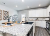 Thumbnail 8 of 39 - a kitchen with a large counter top and a stove top oven