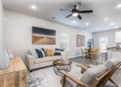 Thumbnail 9 of 39 - a living room filled with furniture and a ceiling fan