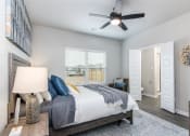 Thumbnail 11 of 39 - a bedroom with a bed and a ceiling fan