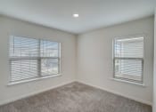 Thumbnail 20 of 46 - Homes In North Denton, TX For Rent - Beall Way - Spacious Bedroom With Plush Carpeting, Ceiling Fan, And Windows