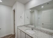 Thumbnail 21 of 46 - an empty bathroom with a sink and a mirror