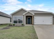 Thumbnail 26 of 46 - a brand new house with a driveway and a garage door