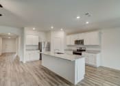 Thumbnail 28 of 46 - a kitchen with white cabinets and a marble counter top
