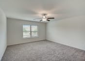 Thumbnail 30 of 46 - an empty room with a ceiling fan and a window