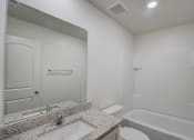 Thumbnail 32 of 46 - the preserve at ballantyne commons apartment bathroom with tub and sink and shower