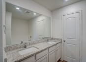 Thumbnail 35 of 46 - a bathroom with two sinks and a mirror