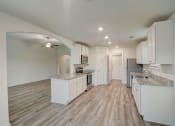 Thumbnail 38 of 46 - an open kitchen with white cabinets and marble counter tops