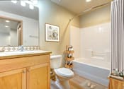 Thumbnail 9 of 15 - a bathroom with a toilet sink and bathtub