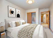 Thumbnail 7 of 15 - a bedroom with a large bed and a closet