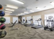Thumbnail 16 of 29 - Twin Oaks Apartments in Hattiesburg Mississippi photo of a spacious fitness center with treadmills and other exercise equipment