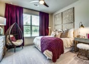 Thumbnail 2 of 18 - One Two and Three Bedroom Apartments in Grand Prairie, TX - Bedroom With Lush Carpeting, Large Window and Stylish Decor